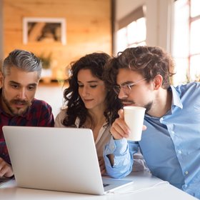 creative-team-watching-project-presentation-laptop