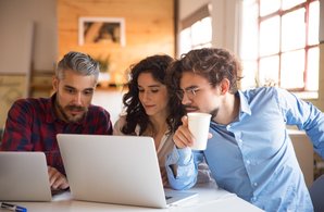 creative-team-watching-project-presentation-laptop