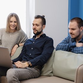 team-three-people-working-laptop-office-sofa