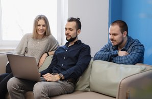 team-three-people-working-laptop-office-sofa